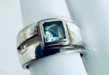 SIGNED STERLING SILVER AND FACETED BLUE TOPAZ WIDE BAND RING