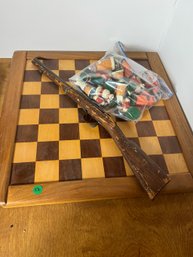 A BENCHMADE CHESS BOARD AND A TOY GUN