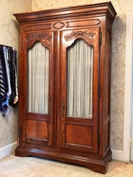 A Large Vintage French Provincial Armoire With Wire Paneled Doors