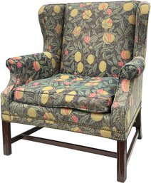 A Vintage Wingback Chair In Tapestry Print With Nailhead Trim