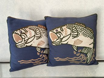 A Pair Of Decorative Throw Pillows With A Fish Motif