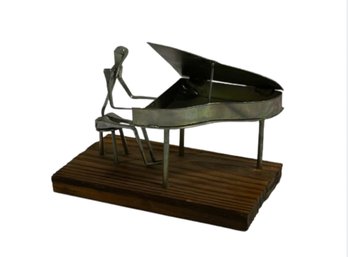 Tin Sculpture Of A Piano Player