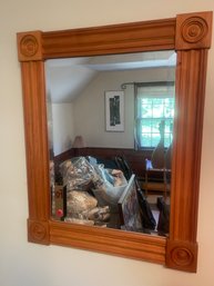 AN ANTIQUE BEVELED OAK MIRROR