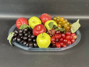 An Assortment Of Faux Fruit On A Tupperware Tray