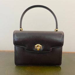 A Vintage Gucci Handbag With Gold Tiger Eye Bar Closure