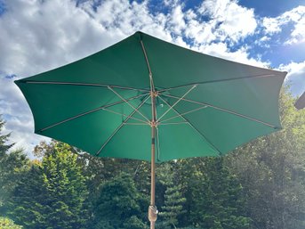 A Market Umbrella In Green With A Weighted Base, 8.5'