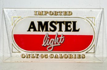 A Vintage Amstel Light Window Advertising Plaque