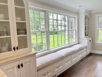 A Custom Built In Window Bench With Glass Front Cabinets - Kitchen