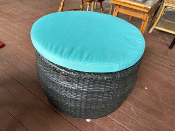 Wicker Ottoman With Turquoise Cushion.