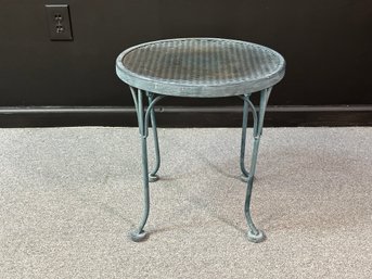 A Small Outdoor Side Table In Metal