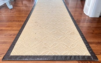 A Large Patterned Sisal Runner With Leather Trim