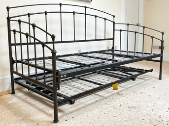 A Wrought Iron Daybed With Trundle