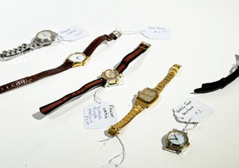 An Assortment Of Watches And Watch Parts