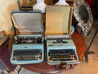 TWO VINTAGE BLUE TYPEWRITERS W/ CASES