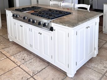 A Kitchen Island With Painted Wood Cabinets With Granite Top (Range Sold Separately)