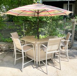 A Vintage Metal And Mesh Outdoor Bar With Striped Umbrella