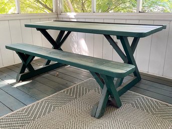 A Rustic Wood Picnic Table And Bench