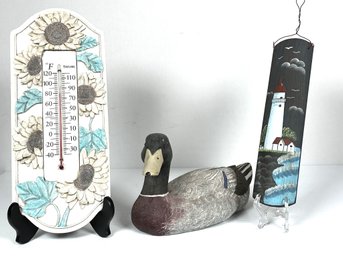 Three Piece Vintage Sunflower Thermometer, A Painted Resin Mallard Duck And A Painted Lighthouse Wall Hanging