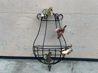 A Pear-Shaped Wall Planter Basket In Rubber Coated Wire Adorned With Little Metal Butterflies