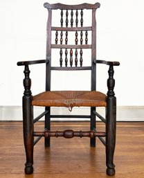 An Antique Carved Oak Arm Chair With Rush Seat