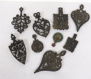 A Selection Of 9 Cast Iron Trivets, Different Designs, Some Wilton