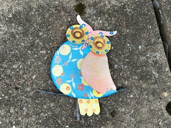 Garden Decor: A Colorful Metal Owl Perched On A Branch