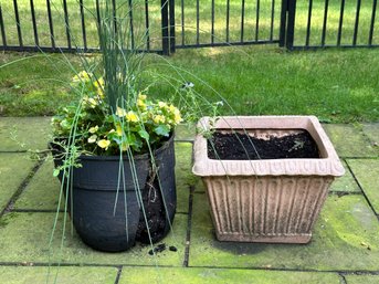 A Cement-Look Square Plastic Planter With Blooming Planter Garden