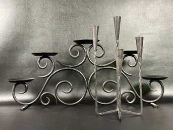 A Selection Of Candle Holders In Black Metal