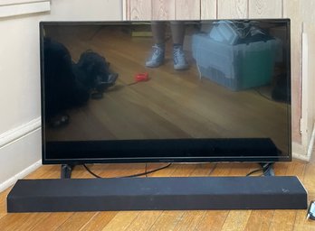 An Insignia 39' Flat Screen TV And Vizio Sound Bar