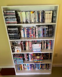 Bookcase And Collection Of VHS Tapes And DVDs