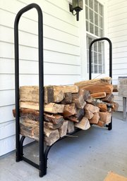 A Tubular Steel Wood Holder Plus Lots Of Extra Firewood
