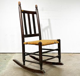 An Antique Rush Seated Rocking Chair