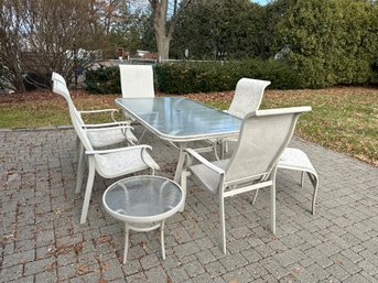 An Outdoor Table With Chairs, Stools & End Table