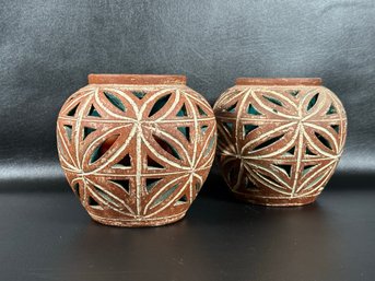 A Pair Of Vintage Ceramic Candle Holders With Geometric Cutouts