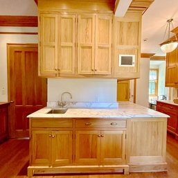 A Custom L- Shaped Upper And Lower Oak Cabinet Unit - Marble Counters And Sink