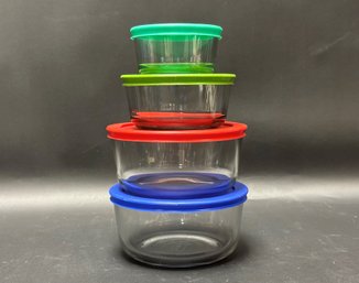 A Stack Of Pyrex Storage Containers