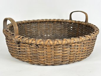 An Antique Wicker Basket With Bent Oak Handles