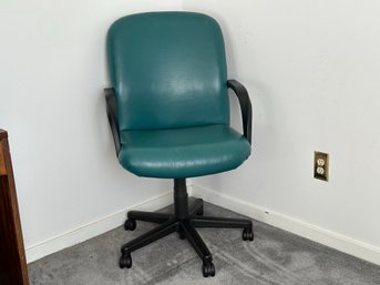 A Desk Chair In Teal Vinyl