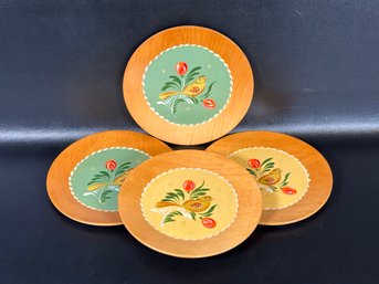 A Set Of Vintage Wooden Plates With Hand-Painted Designs