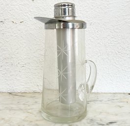 A Vintage Ice Tea Chilling Pitcher In Chrome And Glass