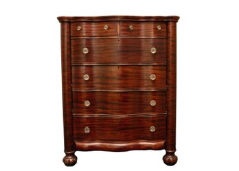 Antique Mahogany Bow Front Dresser With Flame Mahogany Veneer, Glass Knobs, And Column Supports