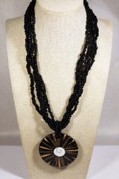 Multi Strand Glass Beaded And Plastic Medallion Necklace