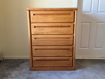 A Tall Chest Of Drawers In Oak