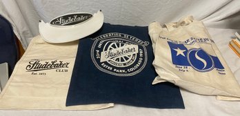 Three Studebaker Bags And Two Foam Visors