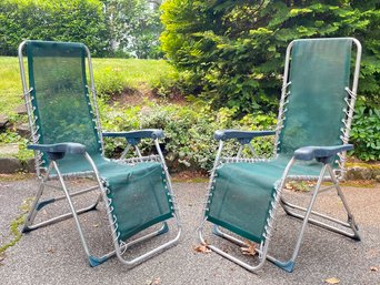 A Pair Of Collapsible Lounge Chairs In Mesh With Aluminum Frames