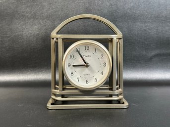 A Desk Clock By Timex With A Metal Cage Case