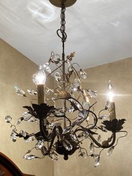 A Powder Room Tole Style Light Fixture With Crystals.