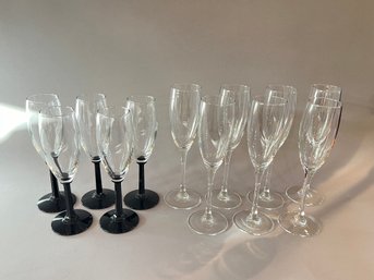 Set Of 5 Black Glass Base Champagne Flutes And 7 French Champagne Flutes