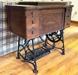 An Antique Oak And Cast Iron Sewing Machine