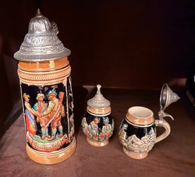 One Large And Two Small Collectible German Stoneware Lidded Beer Steins